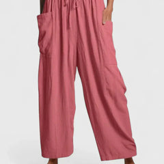 Pink wide-leg trousers with elastic waist and drawstring, side cargo pockets.