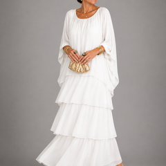 White tiered maxi dress with dolman sleeves and scoop neckline, flowing layered skirt