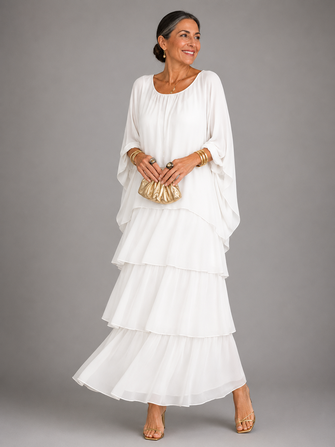 White tiered maxi dress with dolman sleeves and scoop neckline, flowing layered skirt