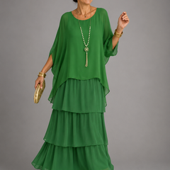 Green tiered maxi dress with dolman sleeves and scoop neckline, flowing layered hem