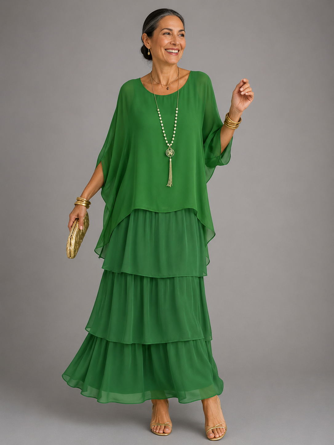 Green tiered maxi dress with dolman sleeves and scoop neckline, flowing layered hem