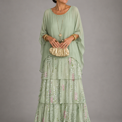 Light green tiered maxi dress with sheer long sleeves and floral ruffle hem