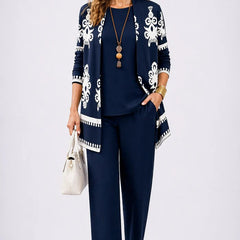 Navy three-piece trouser set with white ornate cardigan and matching top and trousers