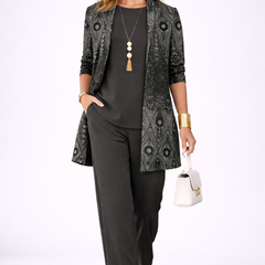 Black three-piece trouser set with patterned blazer, camisole, and straight trousers, necklace