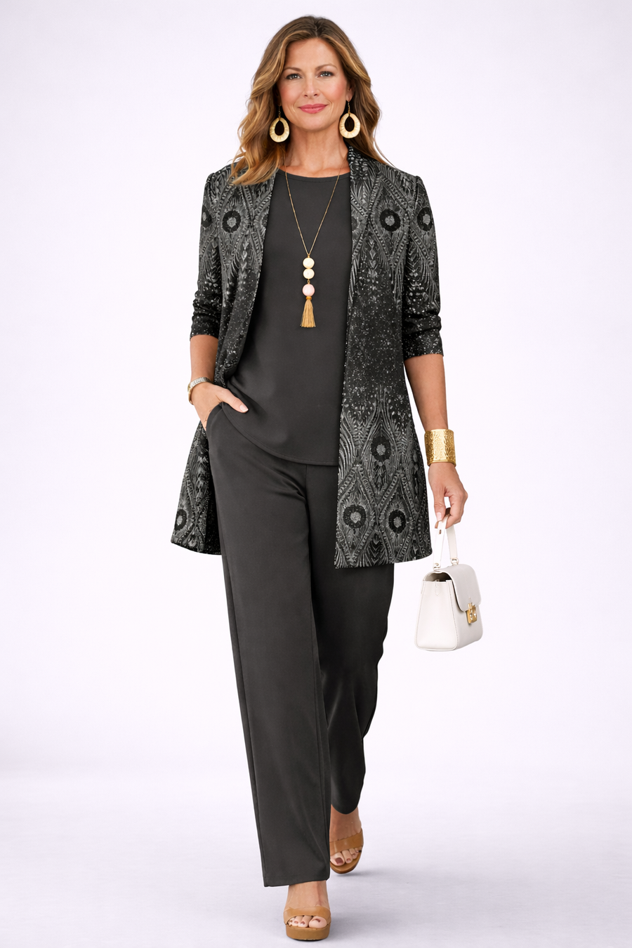 Black three-piece trouser set with patterned blazer, camisole, and straight trousers, necklace