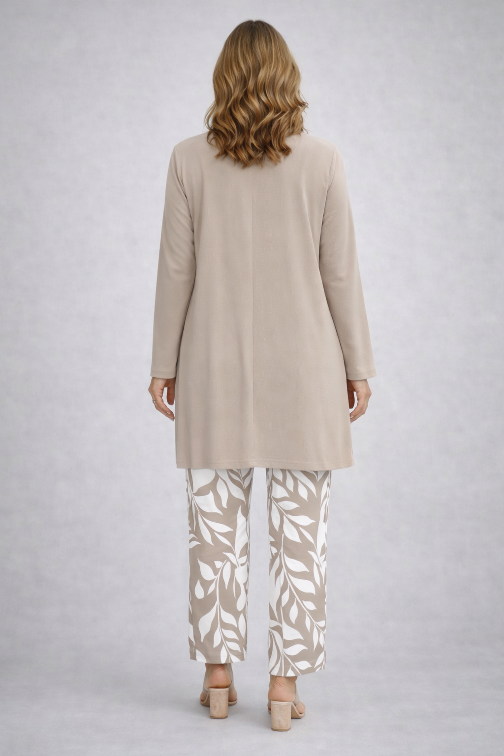 Beige three-piece trouser set, long back tunic over white leaf-print trousers