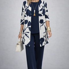 Navy three-piece trouser set with white leaf-print cardigan and matching top and trousers