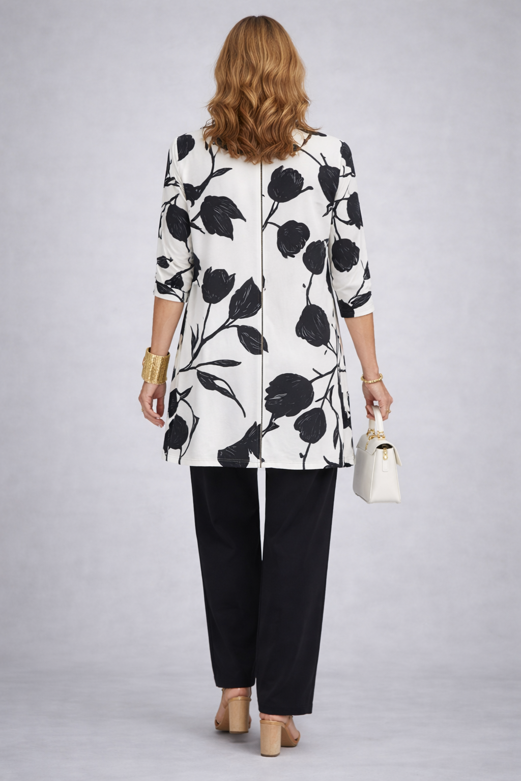 Three-piece trouser set back view: white floral jacket with black trousers