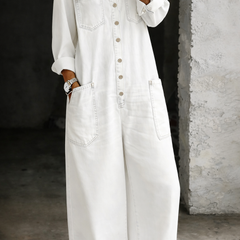 White denim overall with button-front, chest pockets, and wide-leg silhouette
