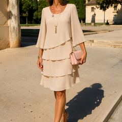Abito elegante color crema con volant a balze e maniche a tre quarti