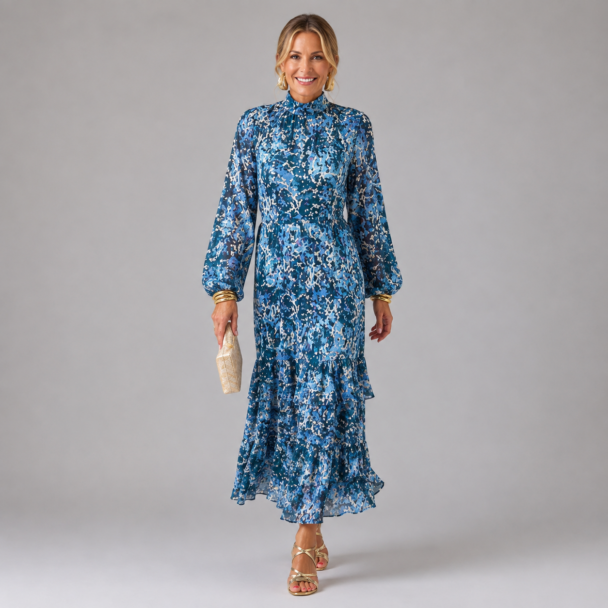 Blue abstract patterned maxi dress with high neck, long sleeves, and tiered skirt
