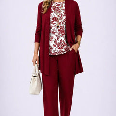 Burgundy three-piece trouser set with patterned blouse, long cardigan, and tapered trousers