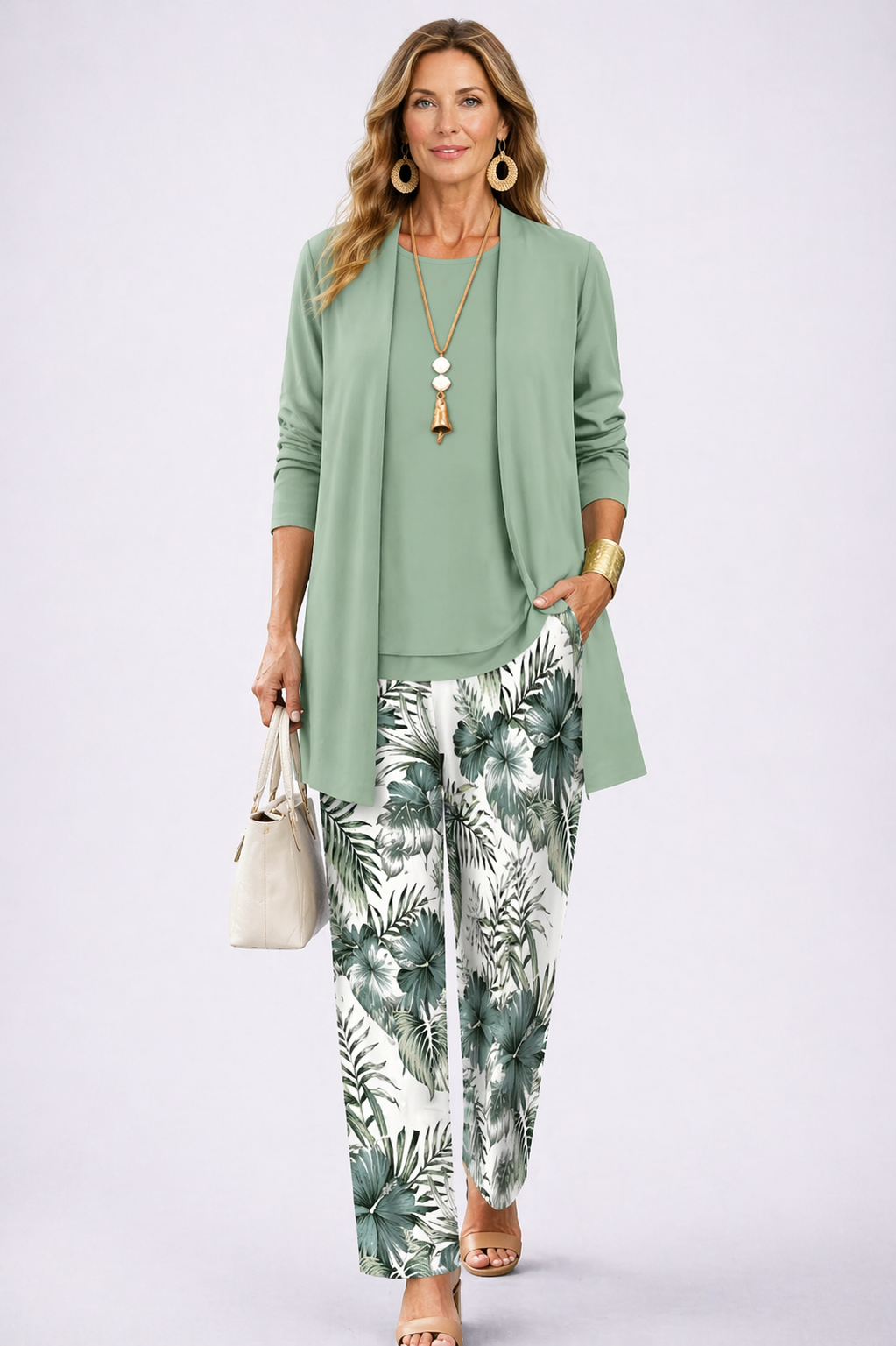 Three-piece trouser set with sage green cardigan, draped blouse, and leaf-print trousers