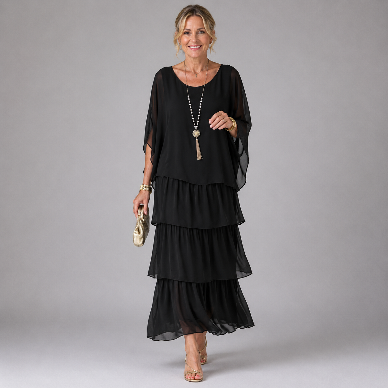 Black tiered maxi dress with sheer flowy sleeves and layered ruffle skirt