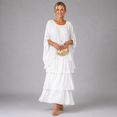 White tiered maxi dress with flowing layered skirt and loose, draped sleeves