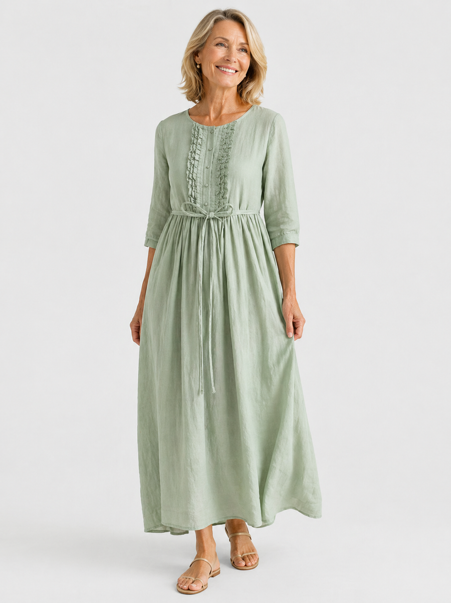 Light green midi dress with three-quarter sleeves, embroidered front, and tied waist