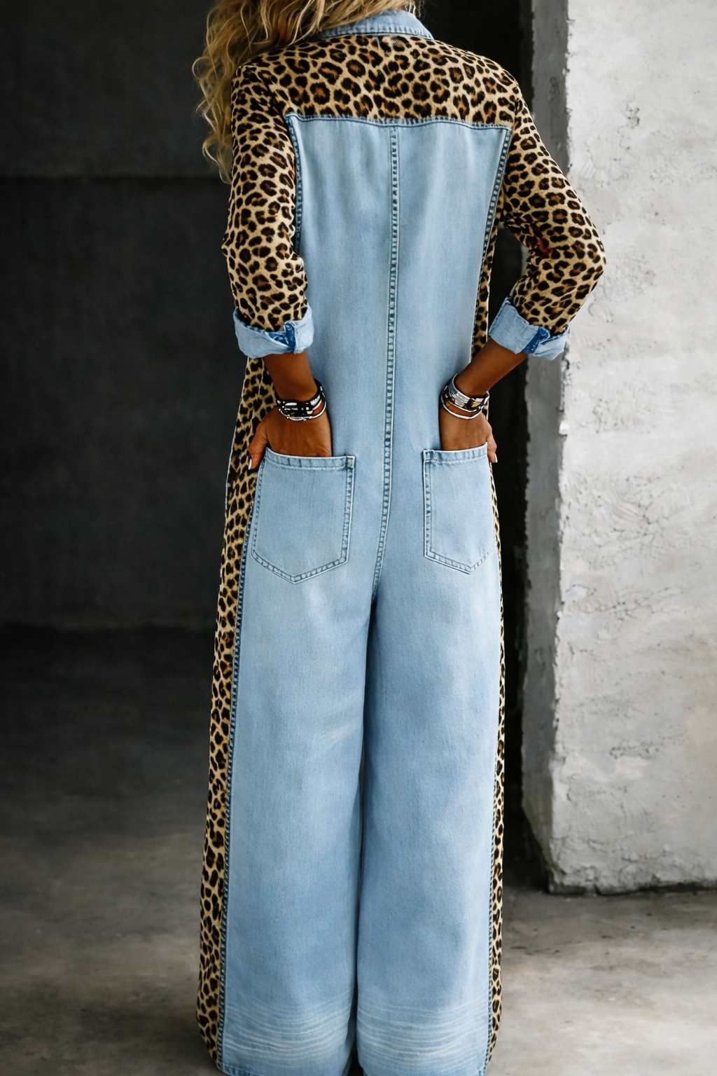 Light blue denim overall back view with button detailing and bib pocket