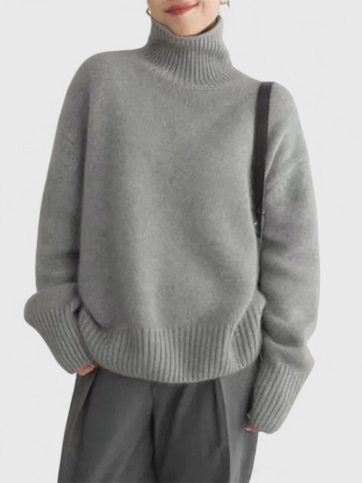 Grey turtleneck knit jumper with long sleeves, ribbed collar and cuffs