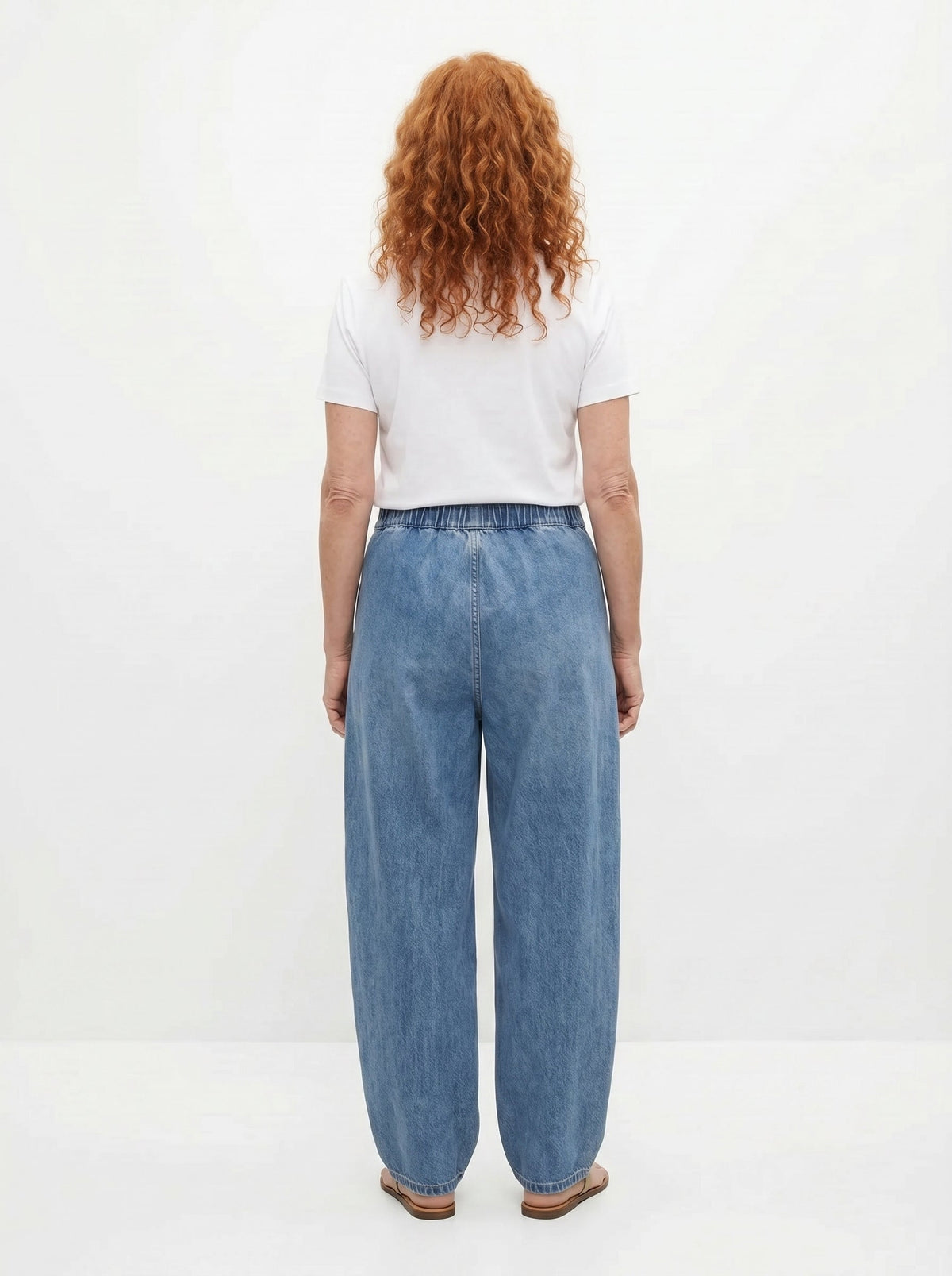 Blue relaxed elastic-waist denim trousers, back view with wide straight legs