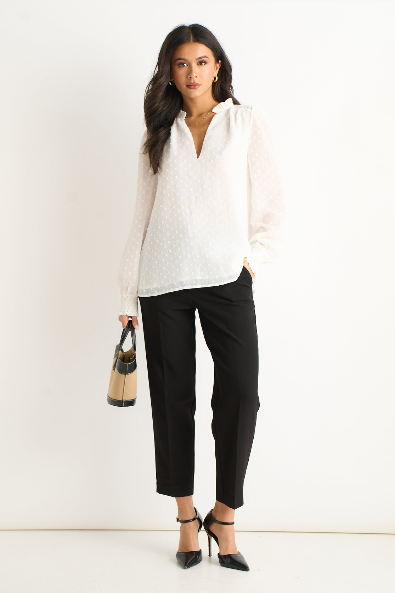 White polka-dot V-neck blouse with frilled neck and long puff sleeves