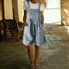 Floral blue denim overall romper with pink floral pattern, front pocket and bib, wide legs