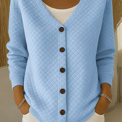 Blue quilted button-front cardigan with V-neck and long sleeves.