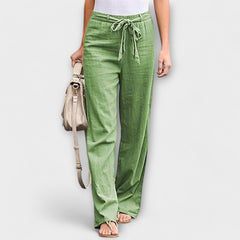 Wide-leg trousers with tie belt, green fabric with elastic waist and airy drape to the floor