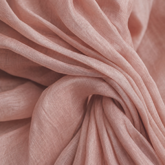Close-up of pink linen-blend fabric with soft drape and gathered folds