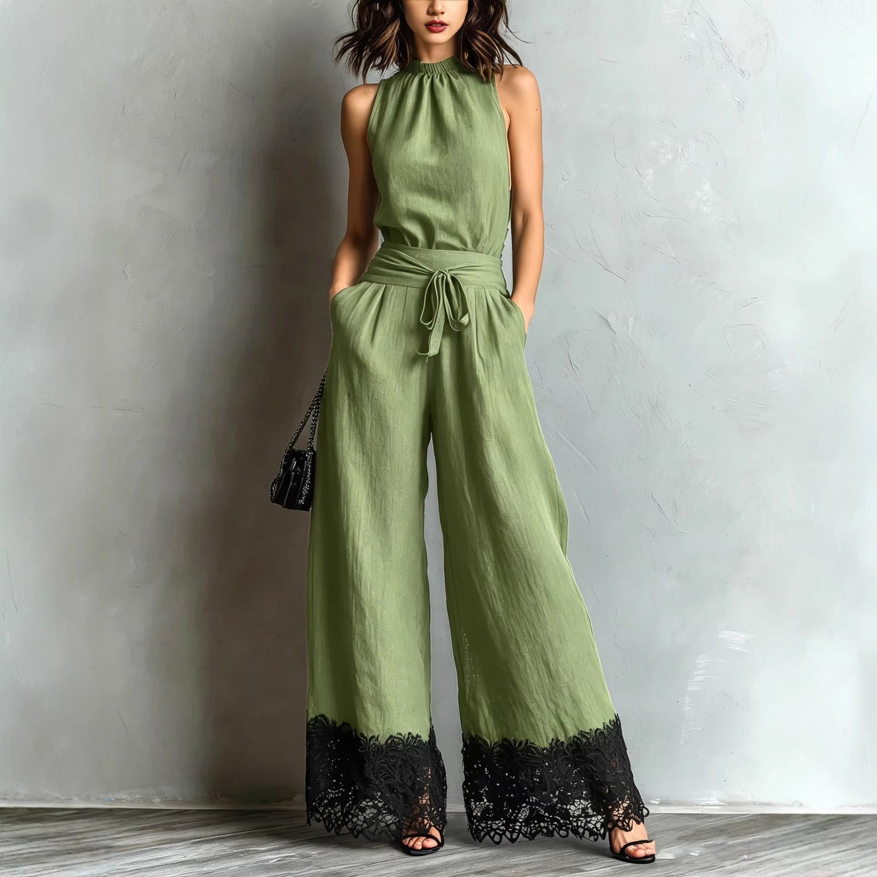 Army green halter-neck lace-trim wide-leg jumpsuit with waist belt tie and black lace cuffs