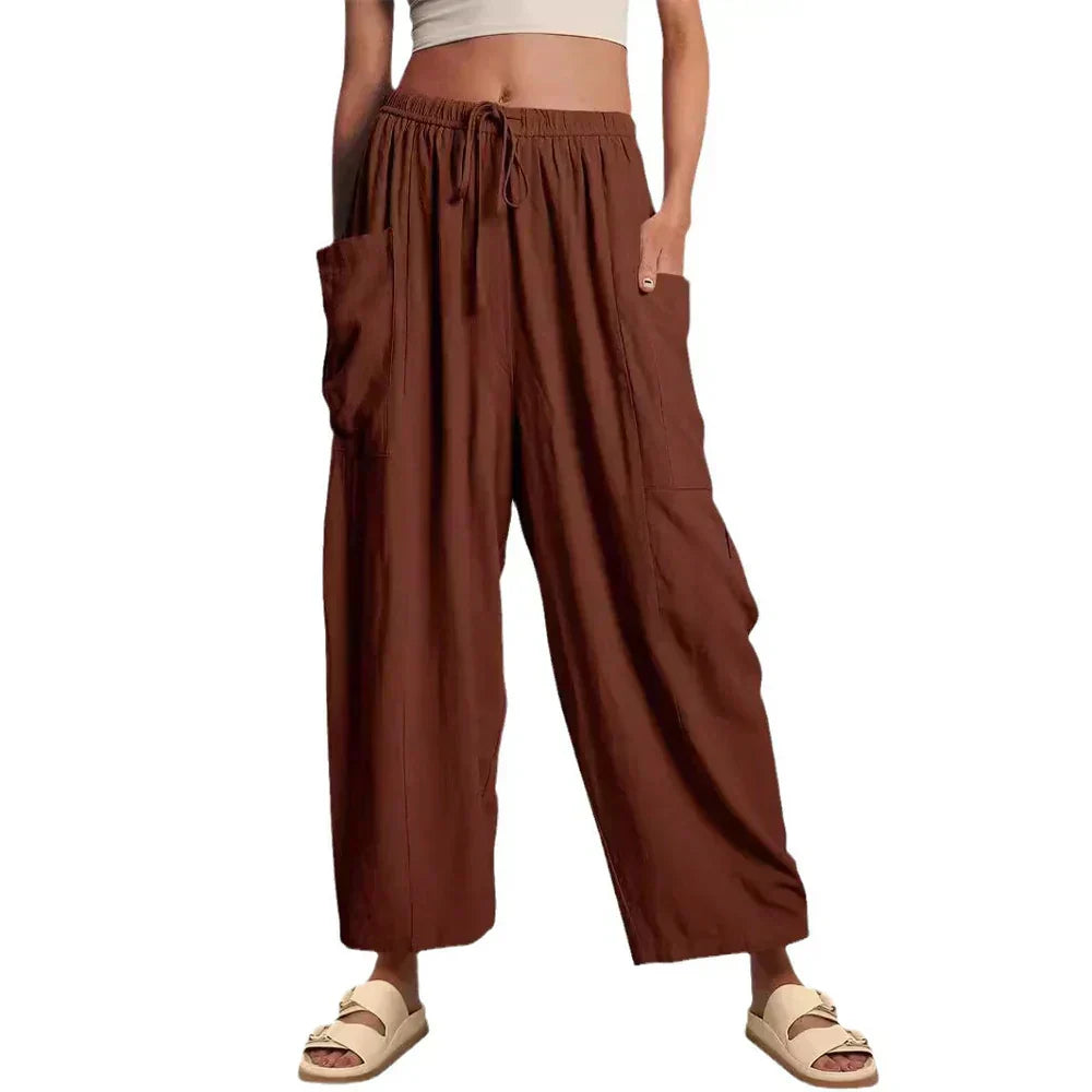 Brown wide-leg trousers with elastic waist and drawstring, side cargo pockets.