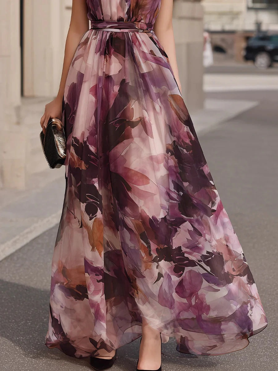 Purple floral maxi dress with belted waist and full flowing skirt, side view