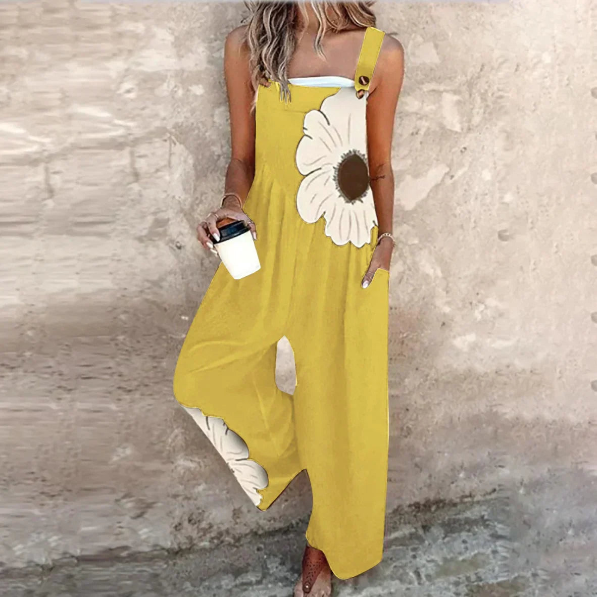 Yellow sleeveless floral printed overalls with wide legs and large cream daisy