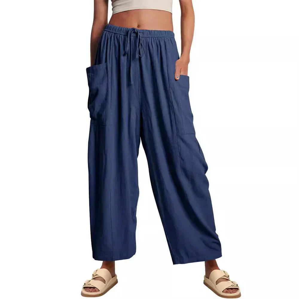 Navy wide-leg trousers with elastic waist and drawstring, side cargo pockets.