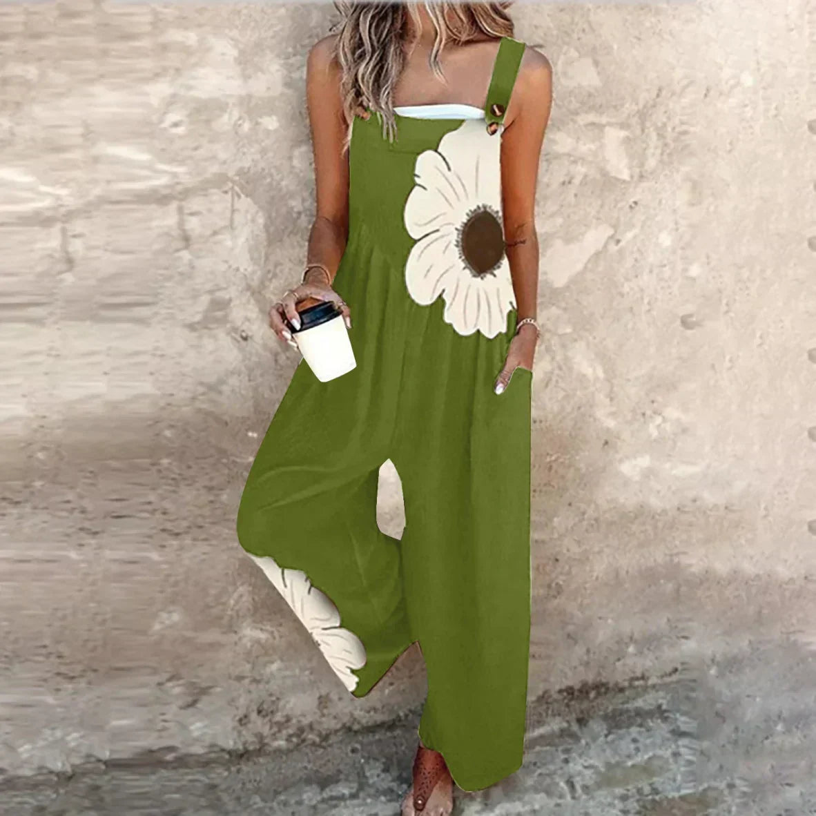 Green sleeveless floral printed overalls with wide legs and large cream daisy