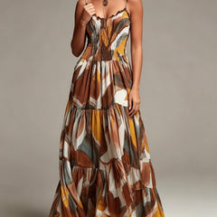 Smocked tiered maxi dress with abstract print, thin straps, and gathered ruffle hem