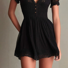 Black mini dress skirt with crochet lace hem and smocked waist seam detail.