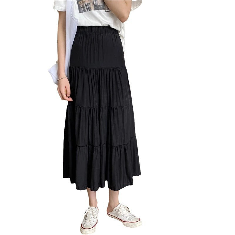 Black tiered midi flowy skirt with elastic waistband and gathered ruffle layers