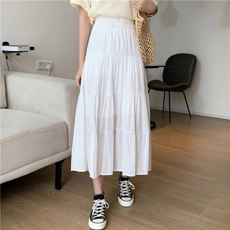 White tiered midi flowy skirt with elastic waistband and gathered ruffle layers