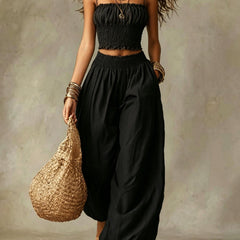 Smocked crop top and wide-leg pants set in black, gathered bodice and elastic waist.