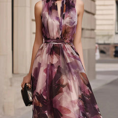 Purple floral sleeveless maxi dress with tie neck and belted waist, pleated bodice
