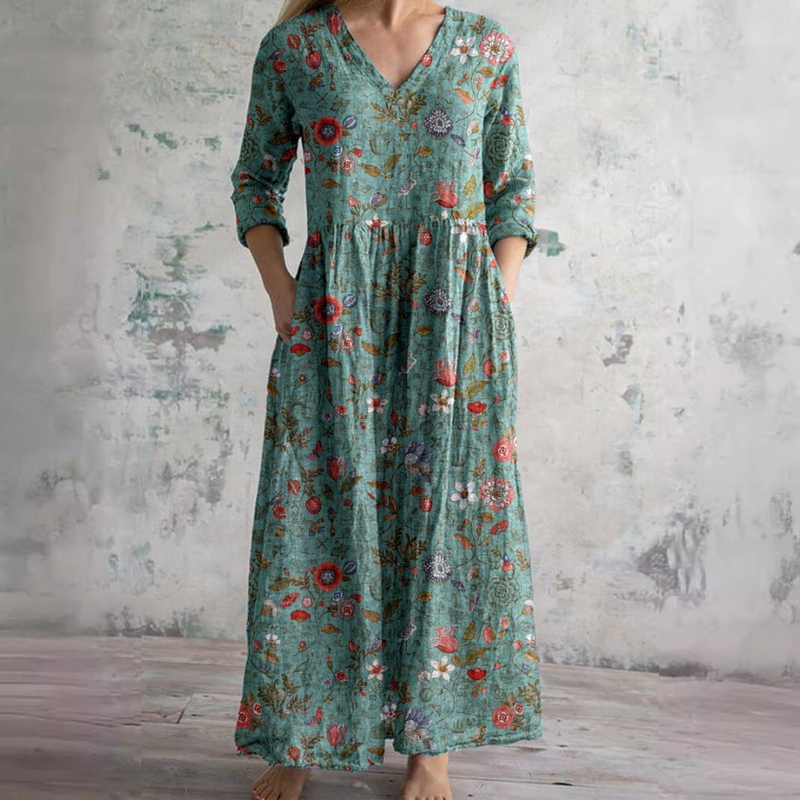 Green floral summer dress with V-neck, three-quarter sleeves, and gathered maxi skirt