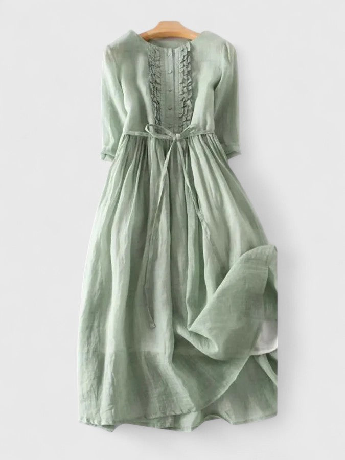 Light green midi dress, back view, with gathered waist tie and textured bodice