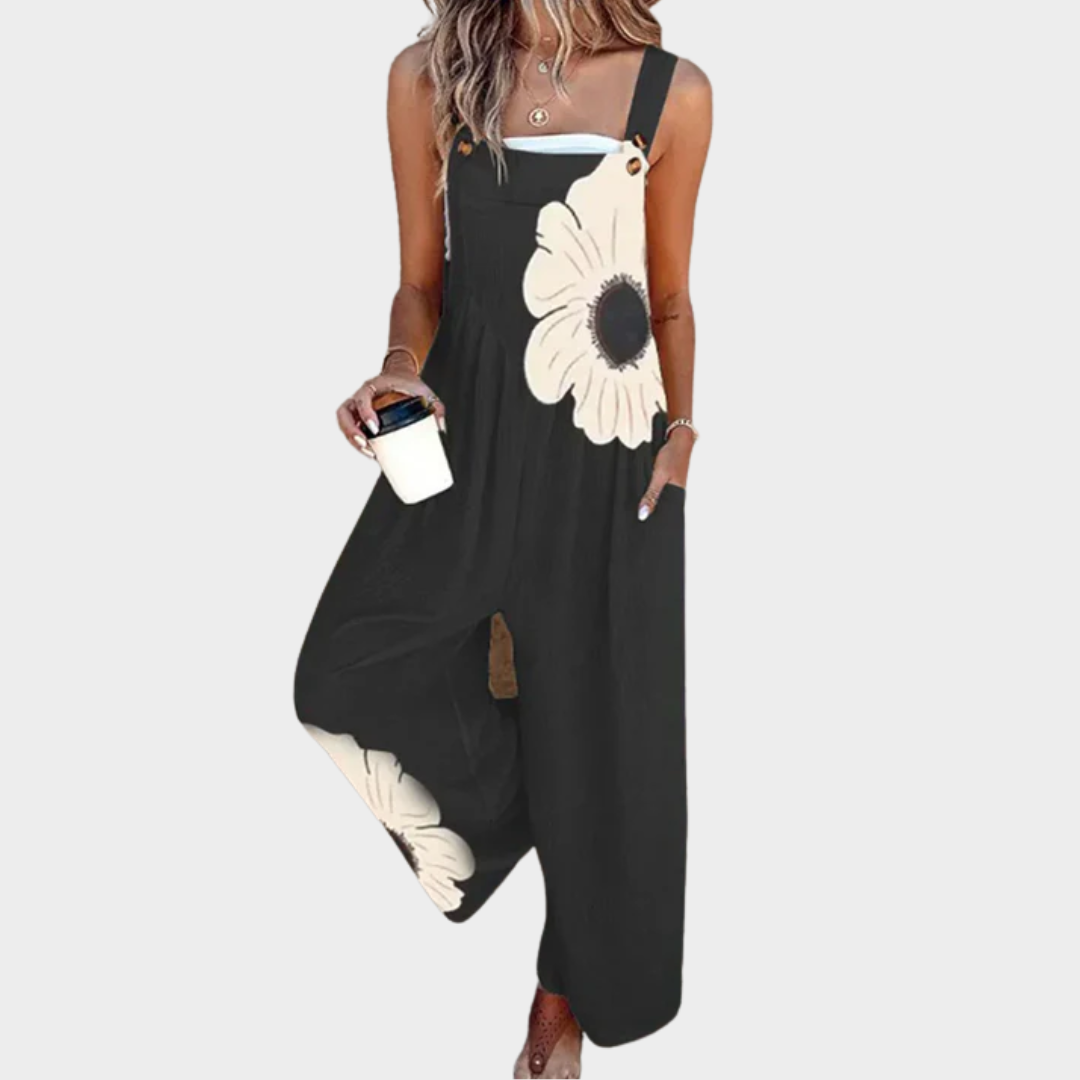 Black sleeveless floral printed overalls with wide legs and buttoned bib strap