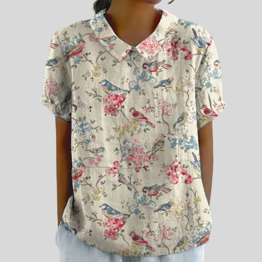 Top in cotone con stampa floreale e uccellini, scollo a V, maniche corte