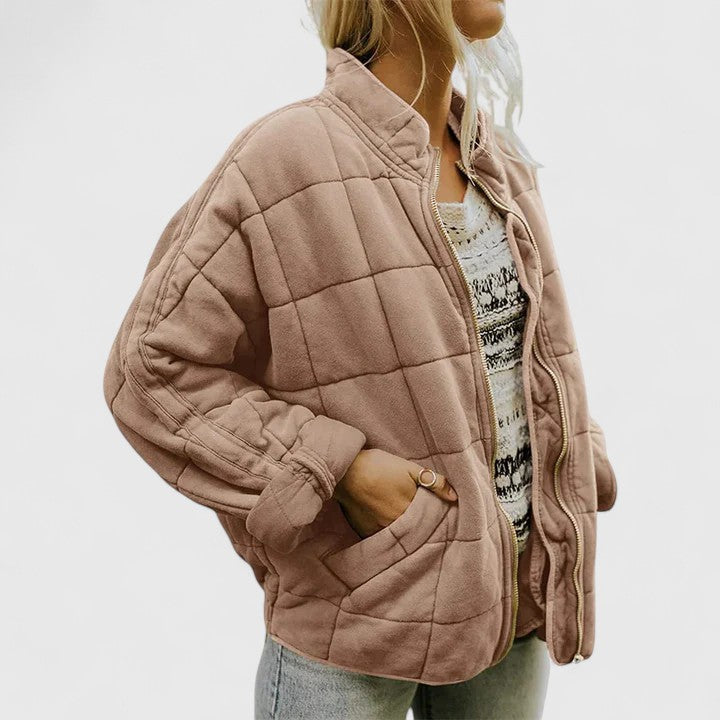 Quilted beige zip-up jacket with stand collar and side pockets, long sleeves