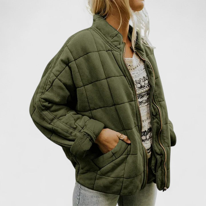 Quilted green zip-up jacket with stand collar and side pockets, long sleeves