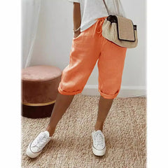 Lightweight summer shorts in orange, rolled hem, drawstring waist, side pockets.