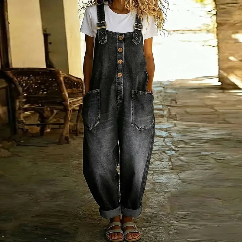 Black denim overalls with adjustable straps, button front, and chest patch pockets.