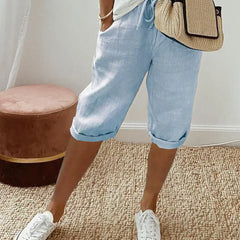 Lightweight summer shorts in light blue with rolled hem and drawstring waist.