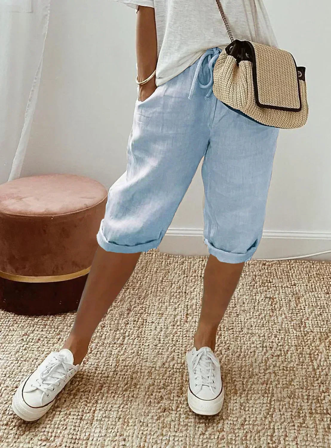 Lightweight summer shorts in light blue with rolled hem and drawstring waist.